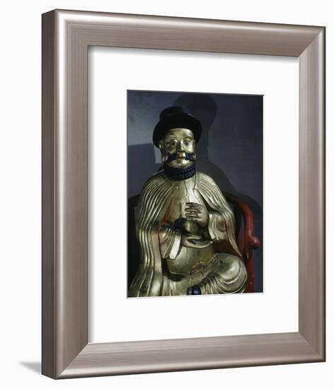 Gilt statue of Marco Polo holding a pomegranate, symbol of wealth and prosperity-Werner Forman-Framed Photographic Print