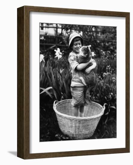 Girl (6-7 Years) Embracing Her Cat-null-Framed Photographic Print