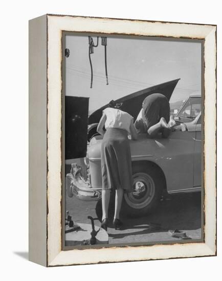 Girl Attendant Looking For Battery For Customer-Allan Grant-Framed Premier Image Canvas