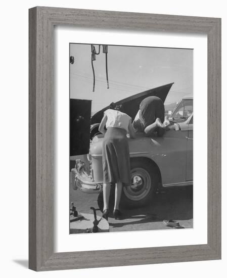 Girl Attendant Looking For Battery For Customer-Allan Grant-Framed Photographic Print