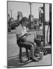 Girl Change Maker Knitting During Slow Moments at the Gilmore Self-Service Gas Station-Allan Grant-Mounted Photographic Print