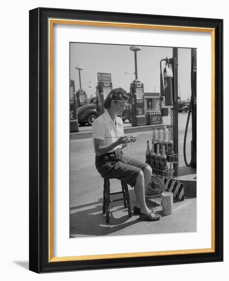 Girl Change Maker Knitting During Slow Moments at the Gilmore Self-Service Gas Station-Allan Grant-Framed Photographic Print