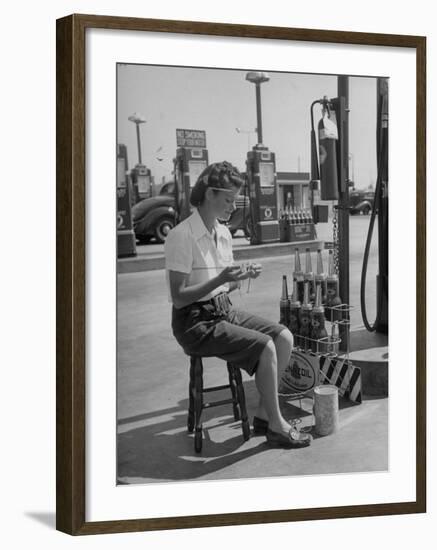 Girl Change Maker Knitting During Slow Moments at the Gilmore Self-Service Gas Station-Allan Grant-Framed Photographic Print