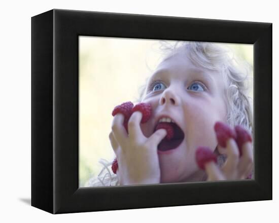 Girl Eating Raspberries, Bellingham, Washington, USA-Steve Satushek-Framed Premier Image Canvas