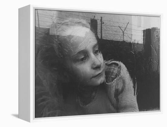 Girl Gazing Pensively Through Pane of Her Apartment Window, Grimly Reflects Image of Berlin Wall-Paul Schutzer-Framed Premier Image Canvas