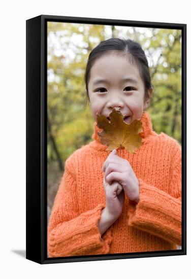 Girl Holding An Autumn Leaf-Ian Boddy-Framed Premier Image Canvas