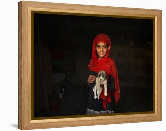 Girl Holds a Puppy as the Sun Sets over Kabul's Impoverished Teppe Maranjan Neighborhood-null-Framed Premier Image Canvas