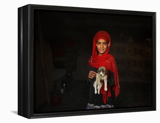 Girl Holds a Puppy as the Sun Sets over Kabul's Impoverished Teppe Maranjan Neighborhood-null-Framed Premier Image Canvas