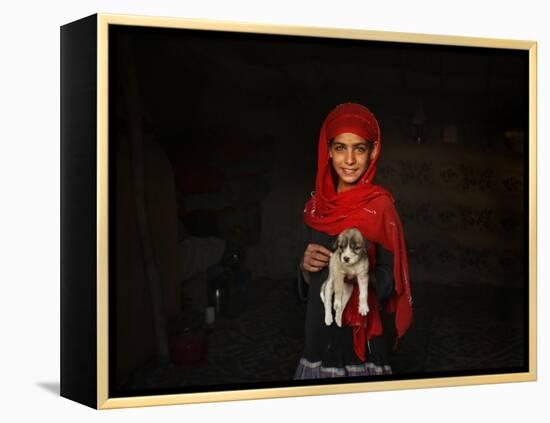Girl Holds a Puppy as the Sun Sets over Kabul's Impoverished Teppe Maranjan Neighborhood-null-Framed Premier Image Canvas