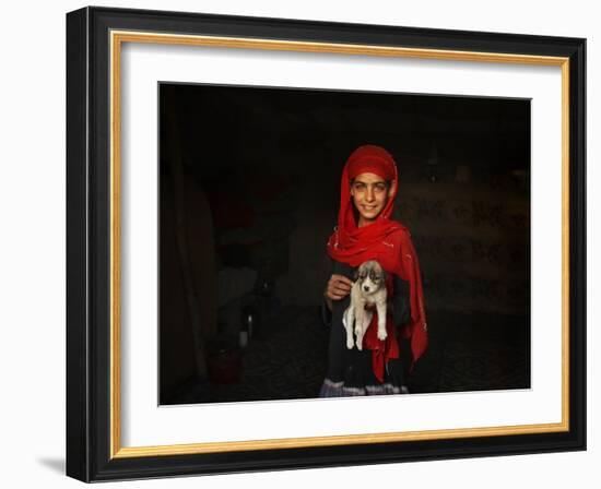 Girl Holds a Puppy as the Sun Sets over Kabul's Impoverished Teppe Maranjan Neighborhood-null-Framed Photographic Print