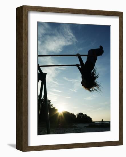 Girl Playing High on Swings at Sunset on Vosu Beach, Located in Lahemaa National Park-Christian Kober-Framed Photographic Print
