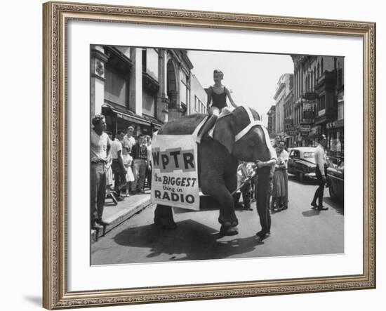 Girl Riding Elephant as a Publicity Stunt for a Radio Station-Peter Stackpole-Framed Photographic Print