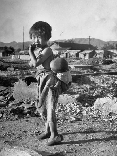 girl standing in rubble