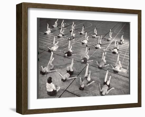 Girls and Women Doing Leg Exercise on Floor of Metropolitan Life Insurance Company's Gym-Herbert Gehr-Framed Photographic Print