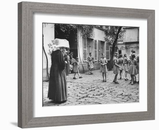 Girls Gathering in the Courtyard of the Mission, Nuns Nearby-null-Framed Photographic Print