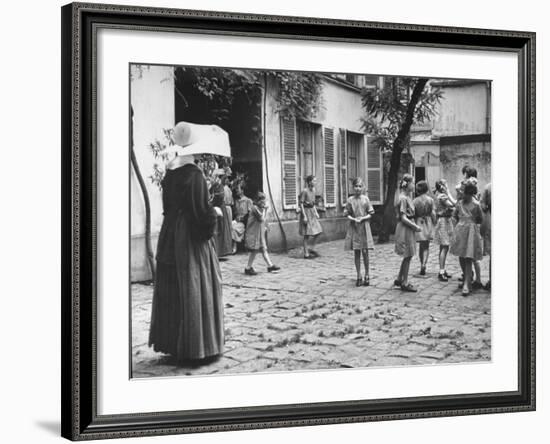 Girls Gathering in the Courtyard of the Mission, Nuns Nearby-null-Framed Photographic Print