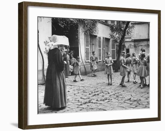 Girls Gathering in the Courtyard of the Mission, Nuns Nearby-null-Framed Photographic Print