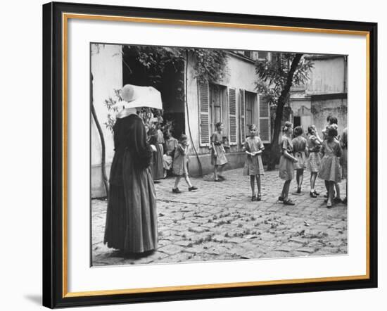 Girls Gathering in the Courtyard of the Mission, Nuns Nearby-null-Framed Photographic Print