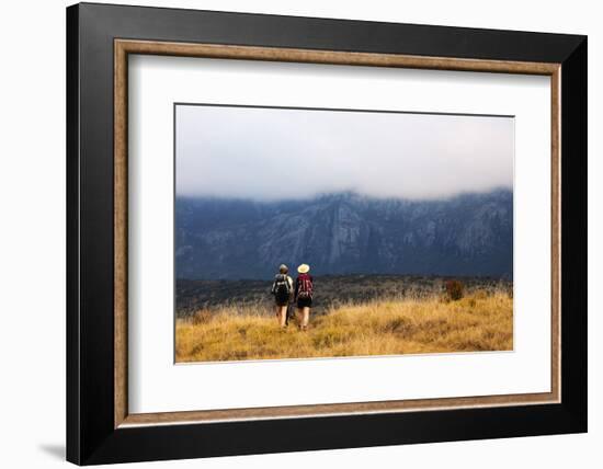 Girls hiking on a trail, Andringitra National Park, Ambalavao, central area, Madagascar, Africa-Christian Kober-Framed Photographic Print