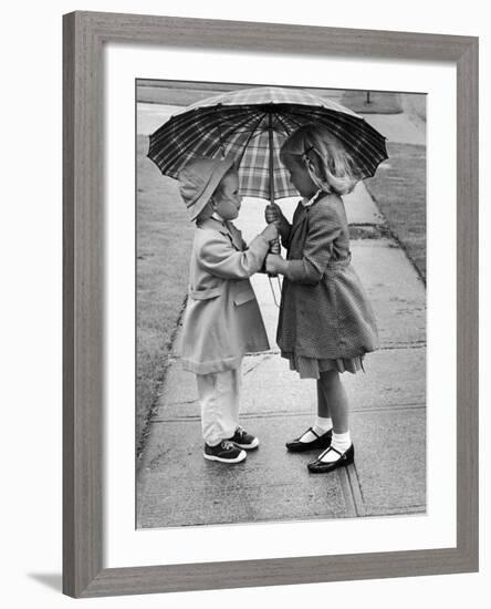 Girls Sharing an Umbrella-Josef Scaylea-Framed Photographic Print