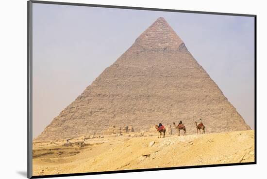 Giza, Cairo, Egypt. Men on camels at the Great Pyramid complex.-Emily Wilson-Mounted Photographic Print