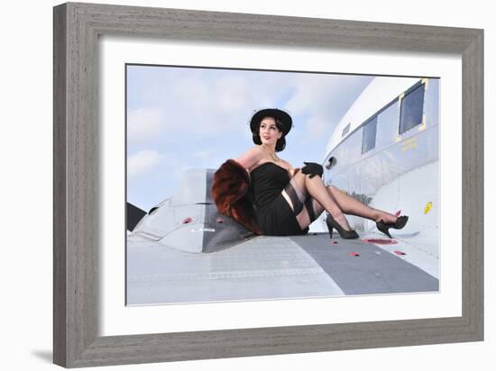 Glamorous Woman in 1940's Style Attire Sitting on a Vintage Aircraft-null-Framed Photographic Print