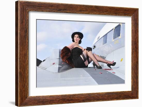 Glamorous Woman in 1940's Style Attire Sitting on a Vintage Aircraft-null-Framed Photographic Print