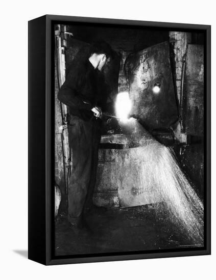 Glass Blower Heating Up Molten Glass Prior to Blowing a Glass Piece at Corning Glass Plant-Margaret Bourke-White-Framed Premier Image Canvas