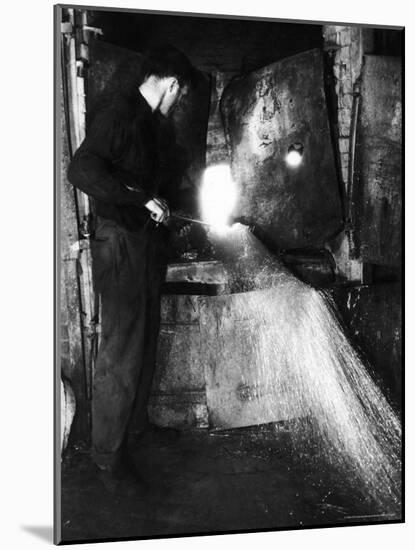 Glass Blower Heating Up Molten Glass Prior to Blowing a Glass Piece at Corning Glass Plant-Margaret Bourke-White-Mounted Photographic Print