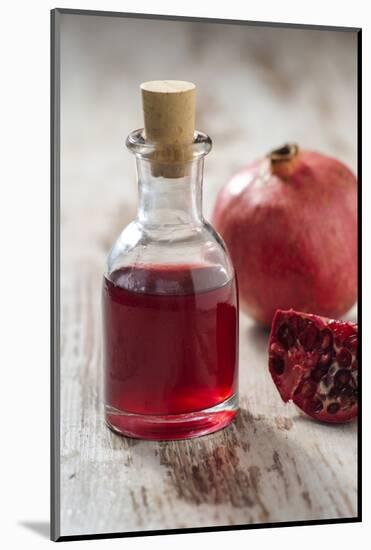 Glass Bottle with Pomegranate Juice and Pomegranate-Jana Ihle-Mounted Photographic Print