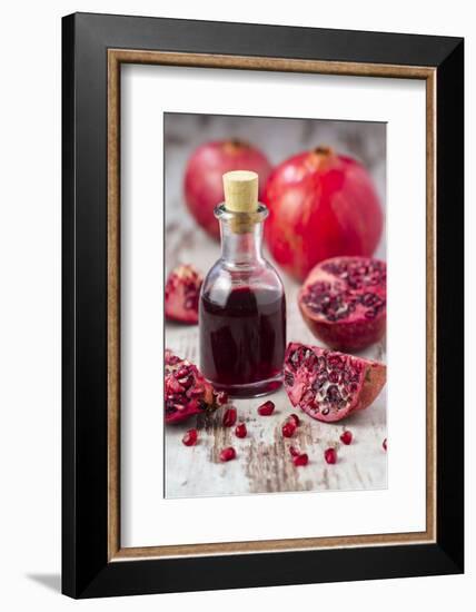 Glass Bottle with Pomegranate Juice and Pomegranates-Jana Ihle-Framed Photographic Print