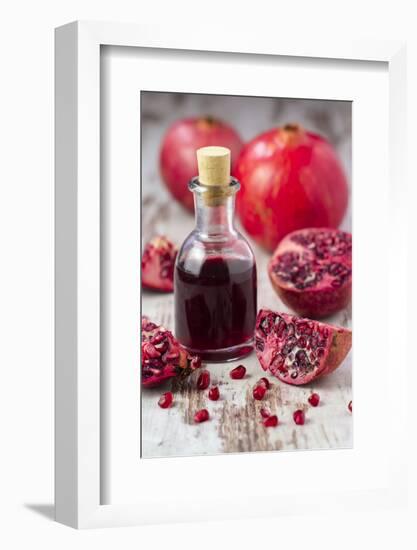 Glass Bottle with Pomegranate Juice and Pomegranates-Jana Ihle-Framed Photographic Print