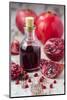Glass Bottle with Pomegranate Juice and Pomegranates-Jana Ihle-Mounted Photographic Print
