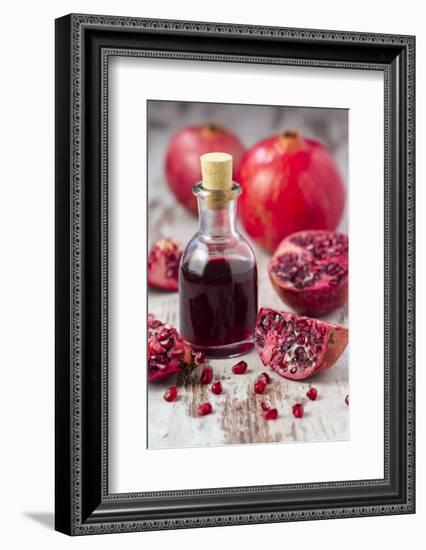 Glass Bottle with Pomegranate Juice and Pomegranates-Jana Ihle-Framed Photographic Print