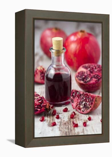 Glass Bottle with Pomegranate Juice and Pomegranates-Jana Ihle-Framed Premier Image Canvas