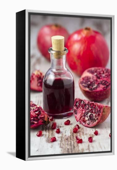 Glass Bottle with Pomegranate Juice and Pomegranates-Jana Ihle-Framed Premier Image Canvas