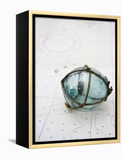 Glass fishing float on chart-Savanah Plank-Framed Stretched Canvas