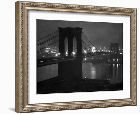 Glittering Night View of the Brooklyn Bridge Spanning the Glassy Waters of the East River-Andreas Feininger-Framed Photographic Print