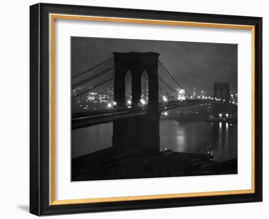 Glittering Night View of the Brooklyn Bridge Spanning the Glassy Waters of the East River-Andreas Feininger-Framed Photographic Print