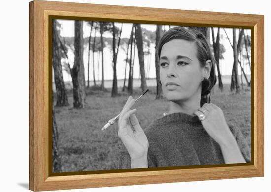 Gloria Vanderbilt Smoking Outside and Showing New Hairdo, 1963-Paul Schutzer-Framed Premier Image Canvas