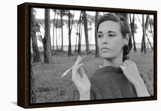 Gloria Vanderbilt Smoking Outside and Showing New Hairdo, 1963-Paul Schutzer-Framed Premier Image Canvas