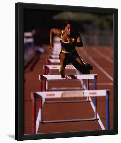 Goals: Runner Jumping Hurdles-null-Lamina Framed Art Print