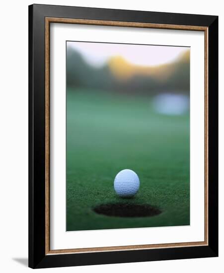 Golf Ball Close to Hole-Robert Llewellyn-Framed Photographic Print