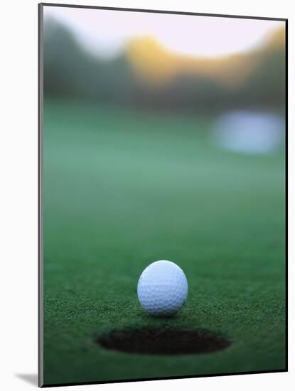 Golf Ball Close to Hole-Robert Llewellyn-Mounted Photographic Print