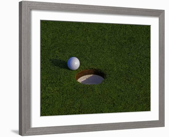 Golf Ball Sitting Near the Hole-null-Framed Photographic Print