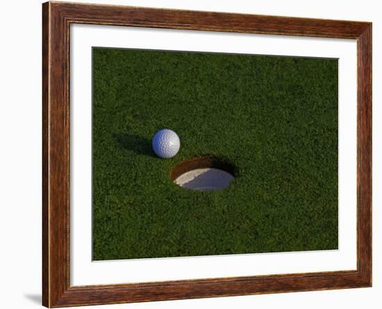 Golf Ball Sitting Near the Hole-null-Framed Photographic Print