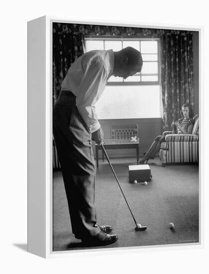 Golfer Ben Hogan Practicing Putting in His town house with Wife Valerie Watching from Armchair-Loomis Dean-Framed Premier Image Canvas