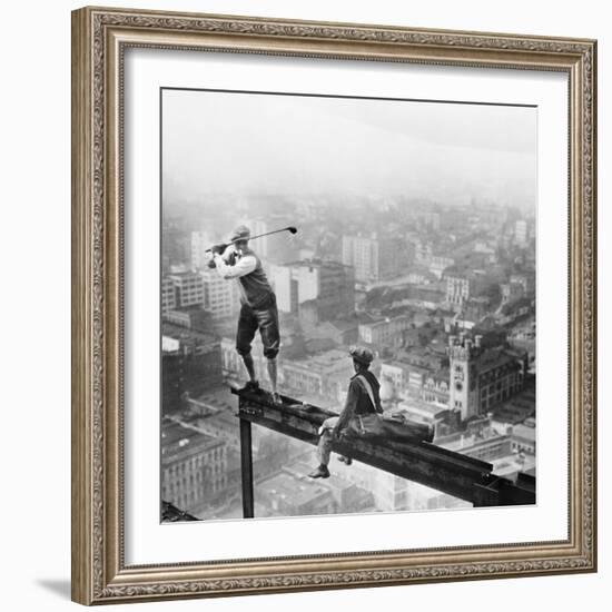 Golfer Teeing off on Girder High above City-null-Framed Premium Photographic Print