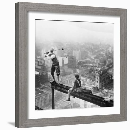 Golfer Teeing off on Girder High above City-null-Framed Photographic Print