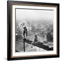 Golfer Teeing off on Girder High above City-null-Framed Photographic Print